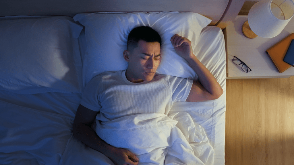 Man laying in bed with his face looking like he is not totally restful. is melatonin addictive