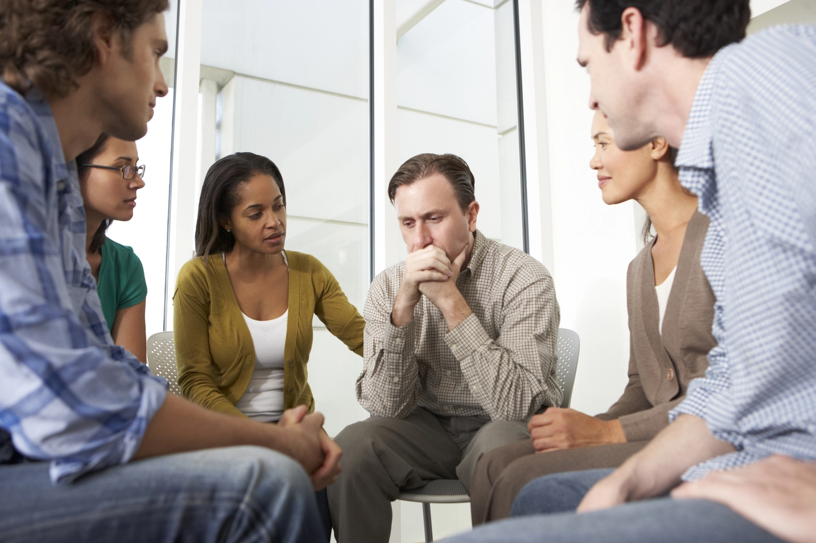 group of people sitting in a circle for alcoholics anonymous counseling