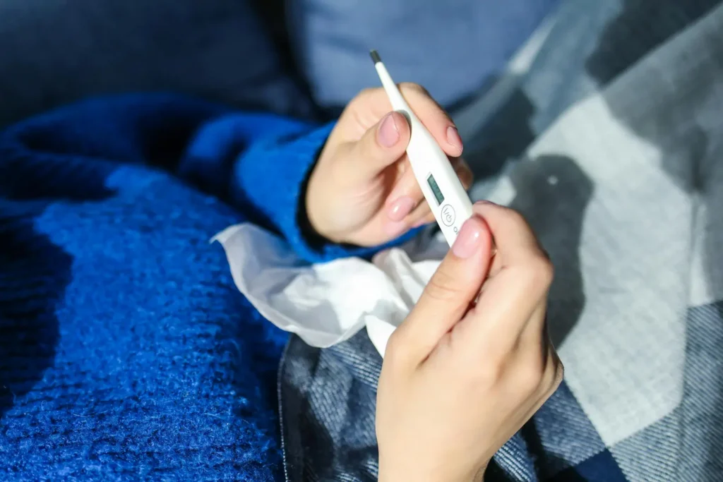 What Is Cotton Fever? An image of a person looking at a thermometer