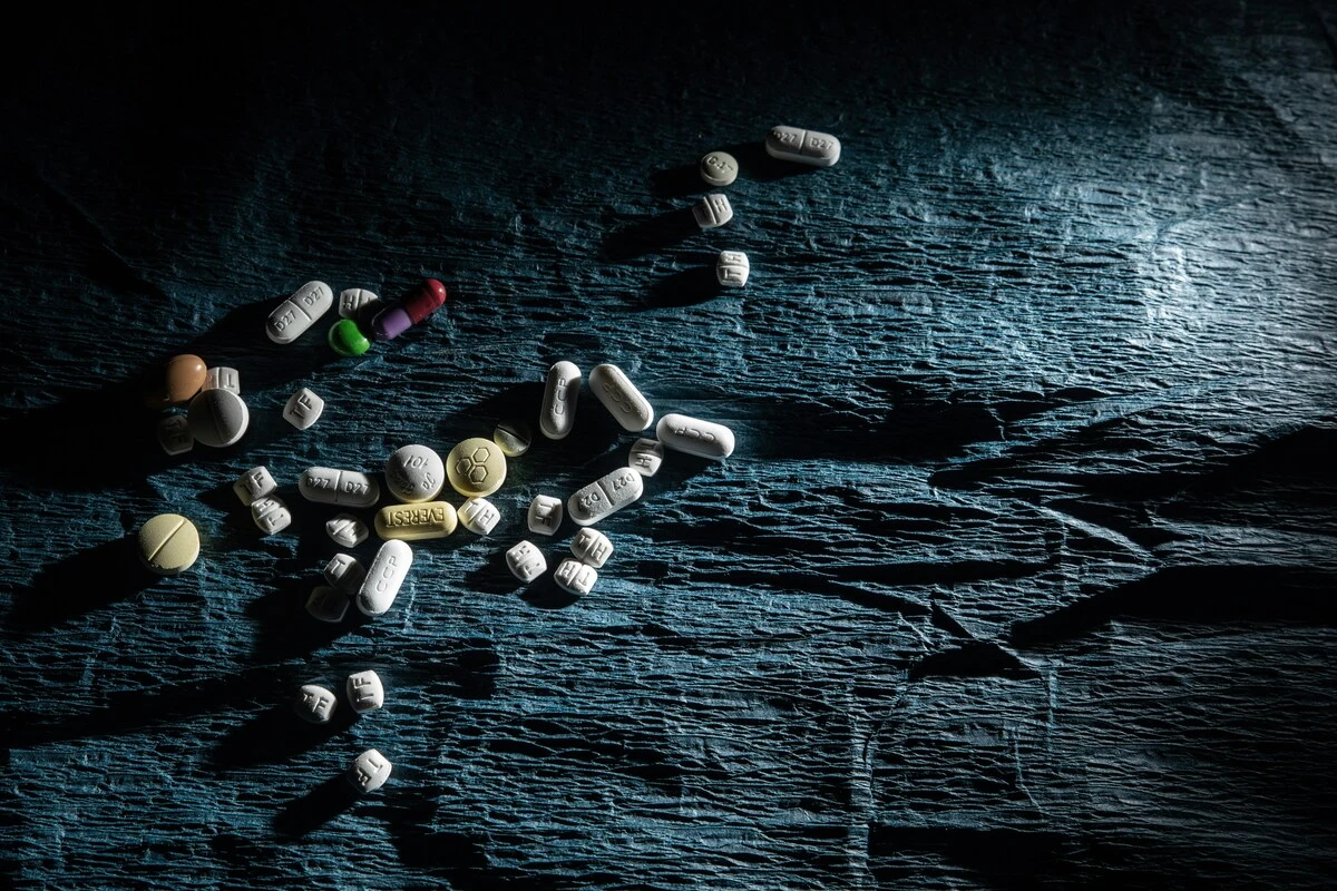 Assorted Klonopin pills on a wrinkled black sheet.