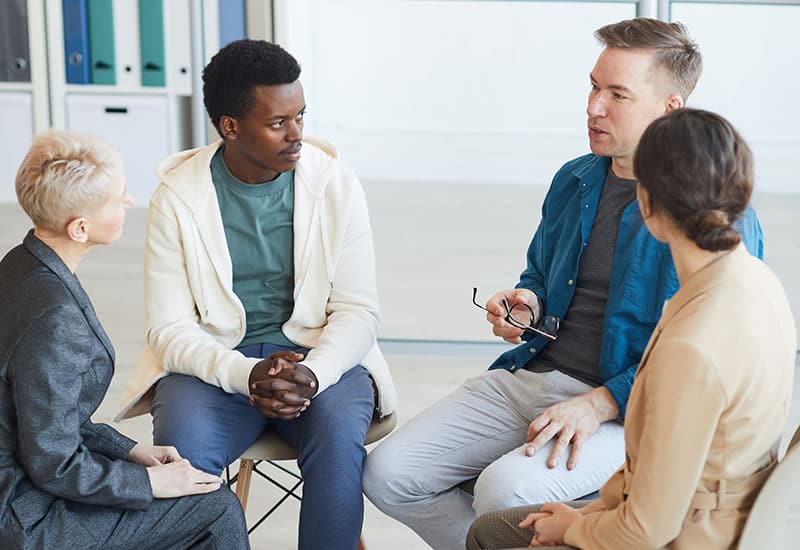 group of people sitting in a circle for alcoholics anonymous counseling