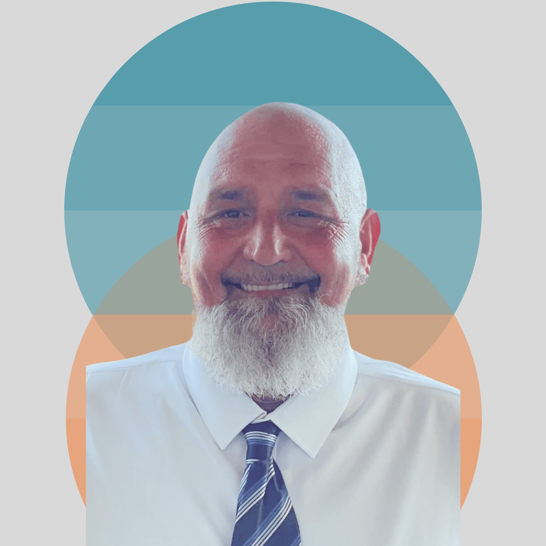 Person in white shirt and striped tie smiling with colorful circle background.