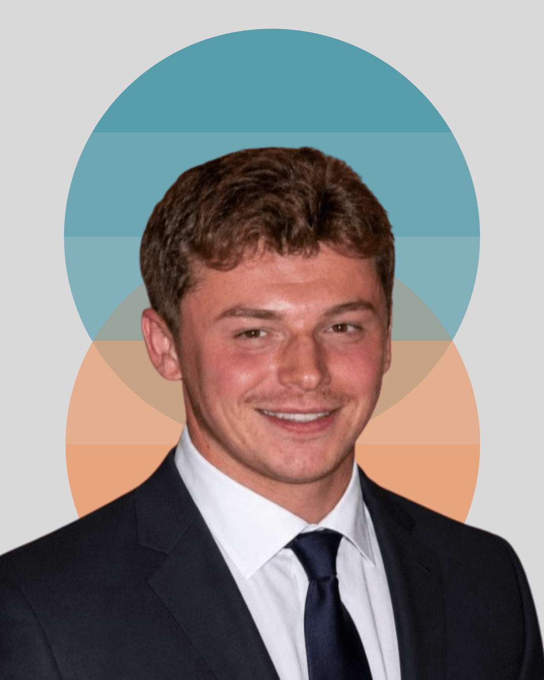 Person in a suit and tie smiling in front of a colorful geometric background.