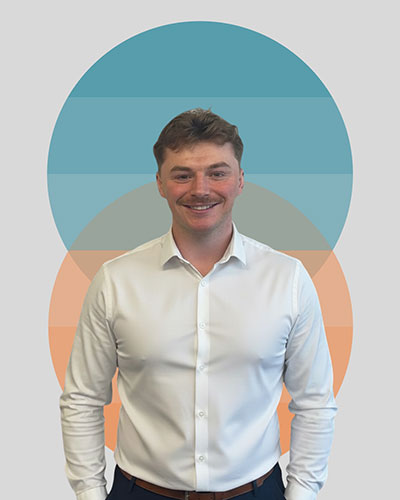Person in white shirt standing with colorful circles background.
